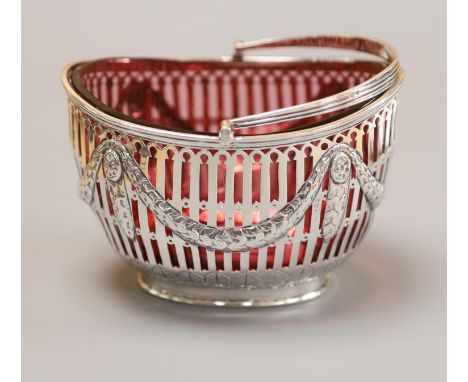 A late Victorian pierced silver oval sugar basket, with cranberry glass liner, Nathan &amp; Hayes, Chester, 1898, height 83mm