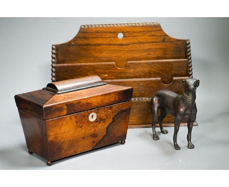 A bronzed metal greyhound, an Edwardian oak letter rack and a sarcophagus tea caddy.