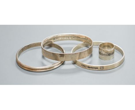 Three modern silver bangles and a large silver band, all by Simon J. Beer of Lewes,191 grams, ring size Z+.