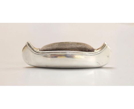 An Edwardian silver mounted pin cushion, modelled as a canoe, Cohen &amp; Charles, Birmingham, 1906. 76mm.