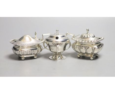 Three assorted 20th century silver mustard pots including Art Nouveau, Birmingham, 1909, tallest 6cm.