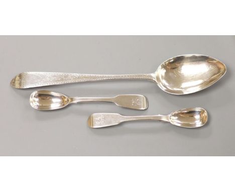 A George III Irish bright cut engraved silver tablespoon, John Shiels, Dublin, 1765 and two Victorian silver mustard spoons, 