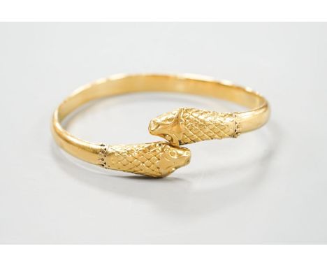 An Indian yellow metal twin headed serpent bangle,53.6 grams.