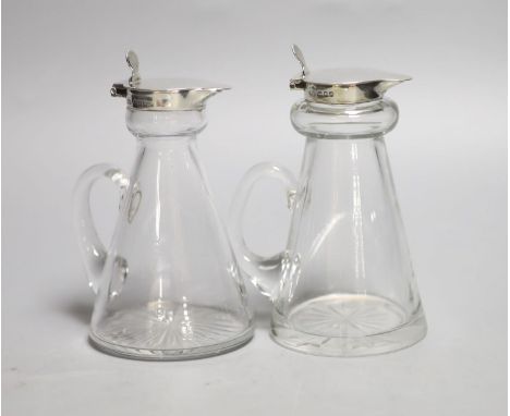Two 20th century silver mounted whisky tot jugs, Birmingham, 1922 &amp; London, 1938, tallest 11.3cm.