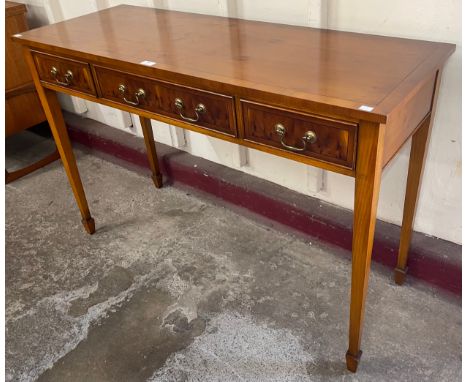 A Regency style yew wood three drawer console table 