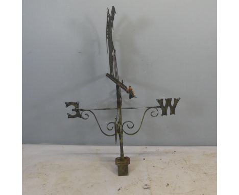 A cast iron weather vane in the form of Old Father Time. Width 77cm, height 115cm.