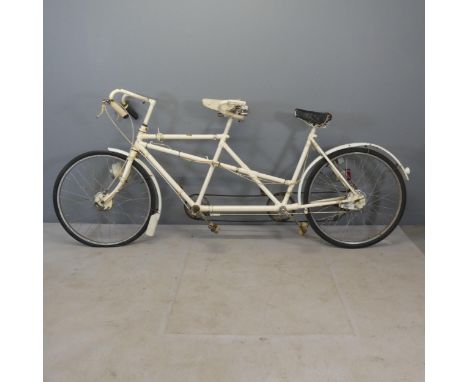 A vintage tandem bicycle, with label for The Hercules Cycle &amp; Motor Company.