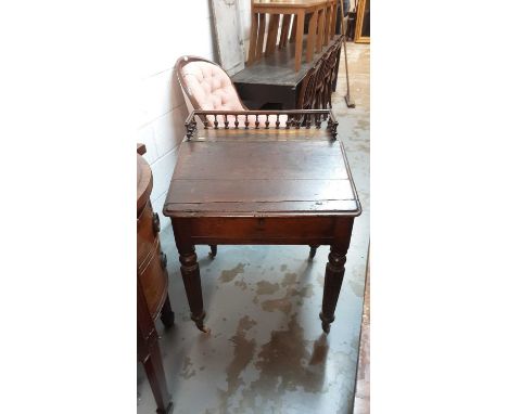 Early 19th century oak clerks desk with gallery back, hinged lid and fitted interior on reeded turned legs and ceramic castor