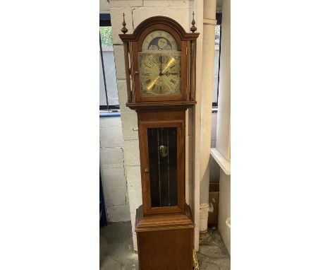 Longcase clock with German 8 day chiming movement, arched brass dial with lunar phase, retailed by Fenclocks of Suffolk. With