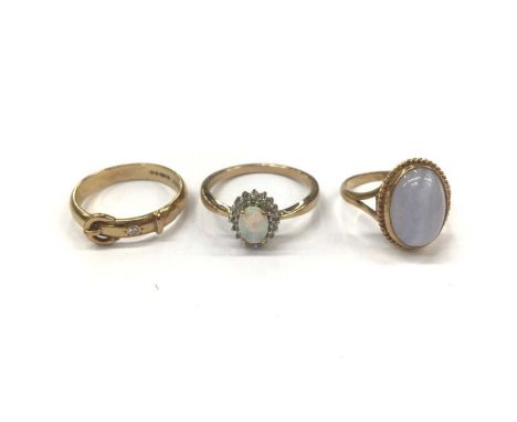 Three 9ct gold dress rings including gold buckle band set with a single stone diamond, size R, opal and diamond cluster, size