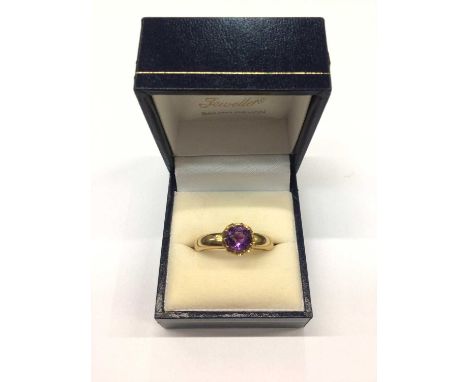 18ct gold amethyst dress ring with a round mixed cut amethyst in claw setting on gold shank stamped 18ct. Ring size U½Weight 