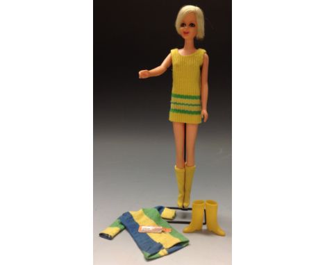 A Mattel Twiggy Barbie doll, wearing a yellow woollen mini dress and long yellow boots, 26.5cm high, c.1967;  the original Tw