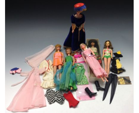 A Mattel Barbie doll, wearing a purple ball gown with floral trim, 27cm high, c.1960;  others, similar;  accessories, other o