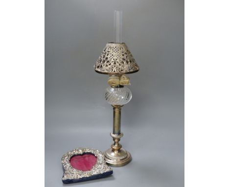 A Victorian plated oil lamp with white metal shade together with a Victorian silver mounted frame