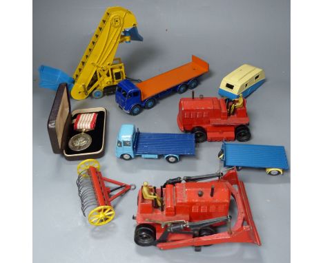 A group of mixed diecast to include Dinky and Corgi toy diggers, tractors, etc. 7 items and a commemorative Canadian medal