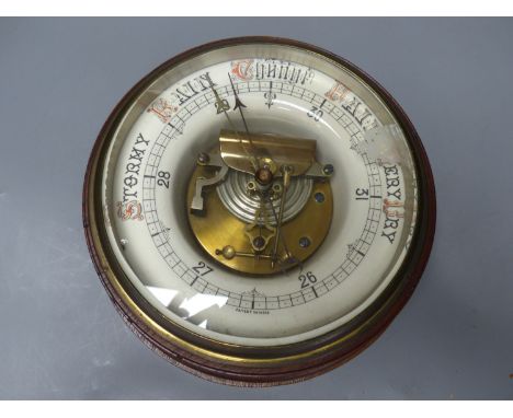 A circular wall mounted aneroid barometer, diameter 25cm