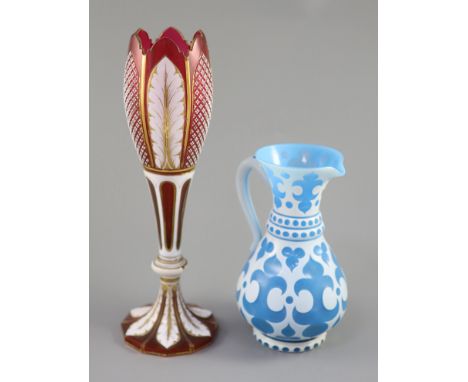 A Bohemian blue and white overlaid glass jug and a similar ruby and white overlaid glass vase, tallest 35cmPlease note 5% Imp