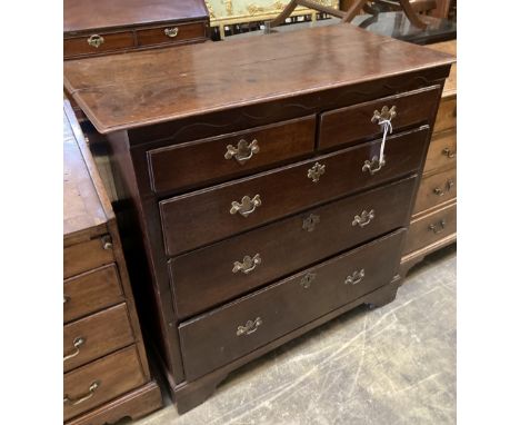 A George II provincial oak chest of two short and three long drawers, with brass drop handles and ogee arched frieze, on brac