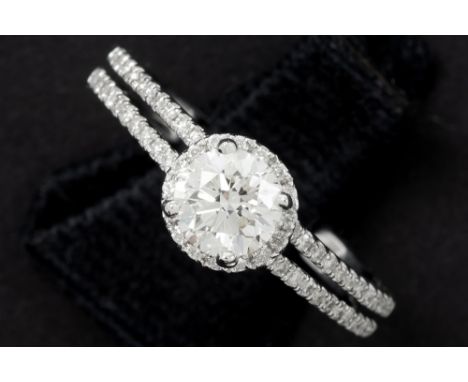 a 0,71 carat high quality brilliant cut diamond set in a ring in white gold (18 carat) with 0,35 carat of small high quality 
