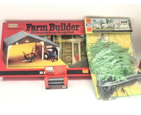 A Boxed Britains Farm Builder Set #4708. A Tree Model Set #1822 and a Metal Hurdles Set #1728.