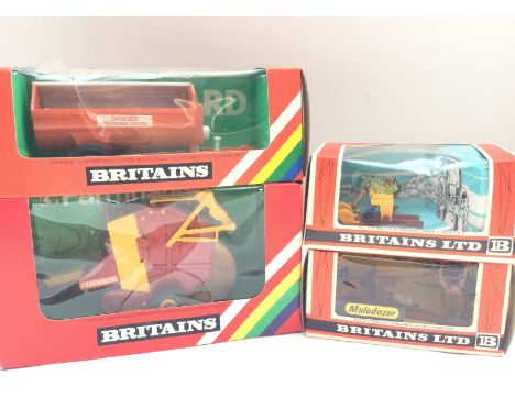 A Boxed Britains Rotary Manure Spreader #9568. A Transplanter #9552. A Round Baler #9532 and a Muledozer #9535.