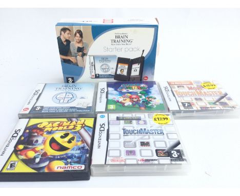 A Boxed Nintendo DS Light and 5 Games.