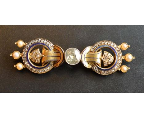 A 15 carat Gold Diamond Pearl and Enamel Set Brooch of scroll form, the central diamond approximately 1.5 carat, flanked by s