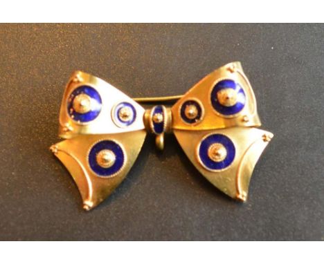 A Yellow Metal Brooch in the form of a bow with blue enamel decoration, 6 grammes, 2 x 4cm 