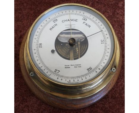 Oak mounted brass cased bulkhead style barometer by Kelvin White Company, Boston, New York (diameter 24cm) 