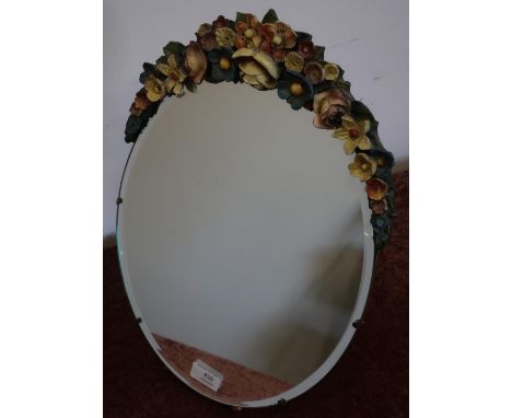 Circa 1930s oval bevelled edge dressing table mirror with easel frame and carved floral pediment (31cm x 43cm) 