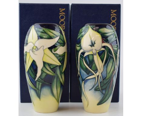 A boxed pair of Moorcroft orchid vases, the first matching pair of vases, one being the Andraecum Orchid Vase and also the Se