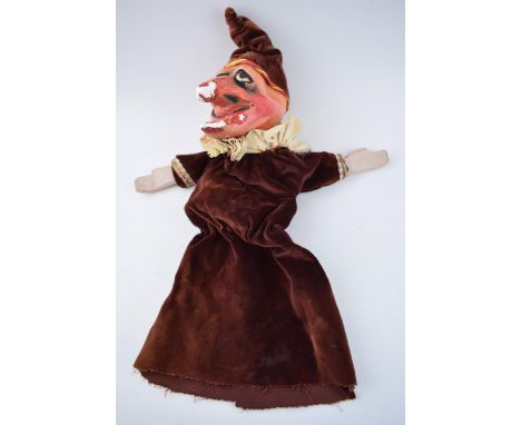 An early 20th century naive plaster hand puppet in the form of Mr Punch in velvet dress with wooden hands, 51cm long.  Displa