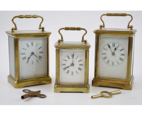 A trio of early 20th century French brass carriage clocks, each with bevelled glass, all unnamed, 2 with keys, tallest 14.5cm