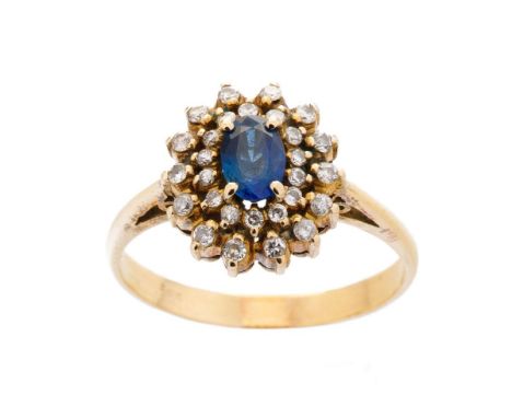 14ct yellow gold sapphire and diamond cluster ring marked .585 to shank. Center oval Ceylon sapphire, claw set with 28 Swiss 