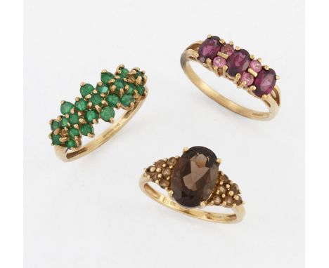 THREE 9 CARAT GOLD GEM-SET RINGS,&nbsp;including&nbsp;AN EMERALD HALF HOOP RING; A SMOKY QUARTZ AND CITRINE RING; and A GARNE