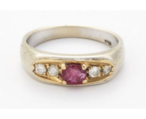 A RUBY AND DIAMOND RING, an oval-cut ruby between pairs of round brilliant-cut diamonds, within a tapering shank. Estimated t