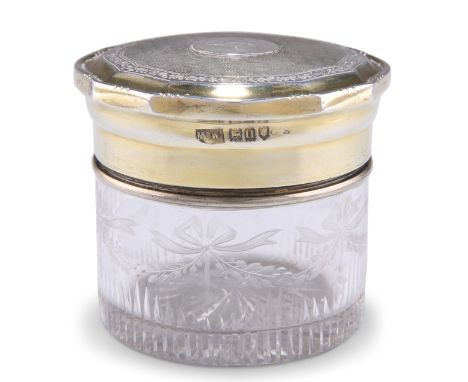 A GEORGE V SILVER-GILT AND CUT-GLASS JAR,&nbsp;by Mappin &amp; Webb Ltd,&nbsp;London 1915, the shaped circular screw-off top 