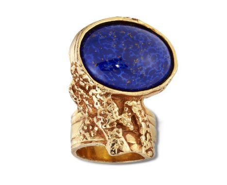 YVES SAINT LAURENT - A GILT-METAL AND PASTE ARTY RING,&nbsp;set with a blue goldstone cabochon. Maker's mark, Ring size 8 / R