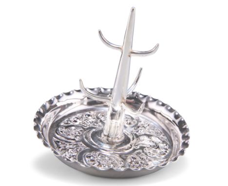 AN EDWARDIAN SILVER RING TREE,&nbsp;by William Hutton &amp; Sons Ltd,&nbsp;London 1901, the dished circular base repoussé&nbs