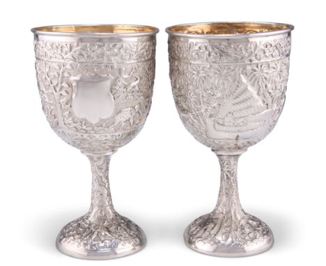A PAIR OF INDIAN SILVER GOBLETS, late 19th Century, repoussé&nbsp;with elephants, lions, figures in boats, etc. (2) 16.5cm hi