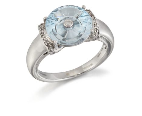 GLENN LEHRER - A 9 CARAT WHITE GOLD BLUE TOPAZ AND DIAMOND 'TORUSRING' RING, a TorusRing-cut blue topaz centre set with a rou