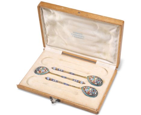 A SET OF THREE RUSSIAN SILVER AND ENAMEL SPOONS, Moscow, c.1882-99, maker 'HC', each picked out with polychrome enamels in a 