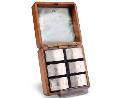 A SET OF SIX ELIZABETH II SILVER NAPKIN RINGS,&nbsp;by&nbsp;Harman Brothers, Birmingham 1974, rounded rectangular form with e