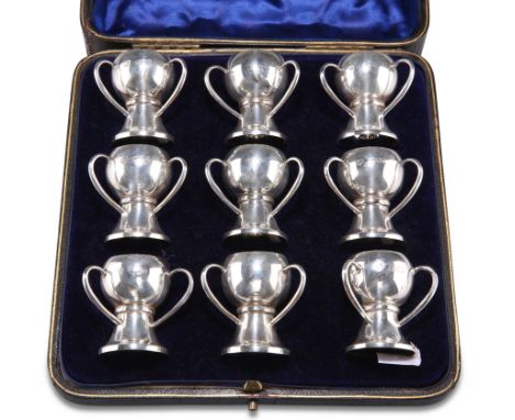 A SET OF NINE EDWARDIAN SILVER CUPS, by Goldsmiths & Silversmiths Co Ltd, London 1906, each of plain bulbous form with three 