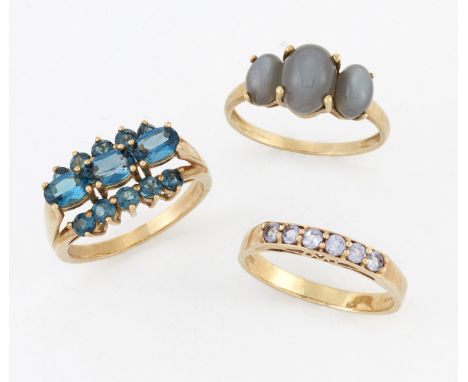 THREE 9 CARAT GOLD GEM-SET RINGS,&nbsp;including&nbsp;A CHATOYANT THREE STONE RING; A HALF HOOP&nbsp;RING; and&nbsp;A TOPAZ R