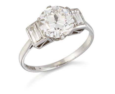 A DIAMOND THREE STONE RING,&nbsp;a round brilliant-cut diamond in a claw setting, between baguette-cut diamonds. Estimated pr