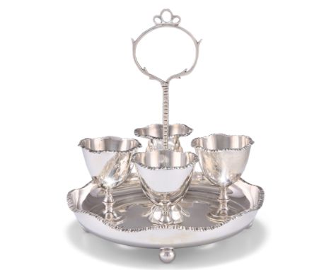 AN EDWARDIAN SILVER EGG CRUET, by William Hutton & Sons Ltd, London 1908, the shaped circular dished stand with notched handl