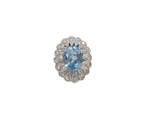 A aquamarine and diamond cluster ring, the central oval aquamarine weight approx 5ct, in a pierced surround followed by 16 ro