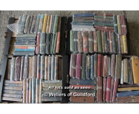 Four boxes of vintage hardback novels, many in dust wrappers, some with pictorial covers.