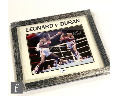 A Leonard V Duran boxing action ring shot, signed by both boxers, certificate to reverse, 30cm x 40cm, framed. 
